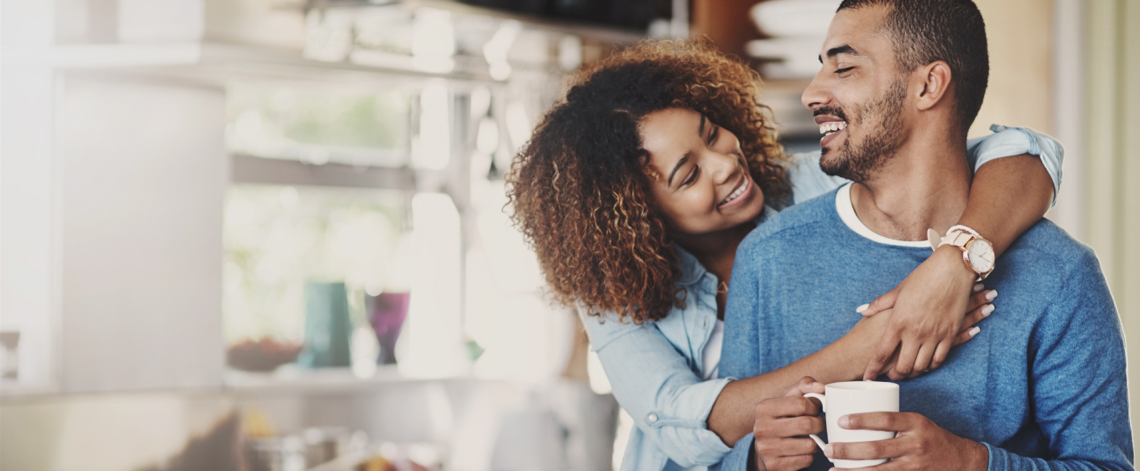 A young couple embracing and smiling