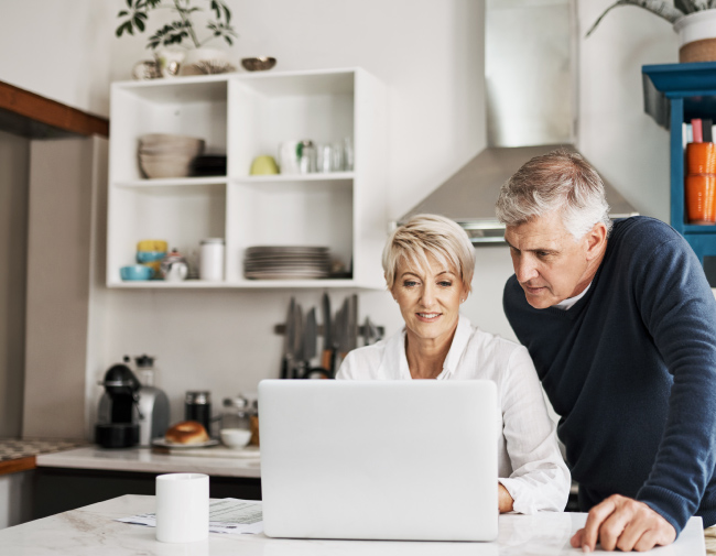 Mature couple looking at laptop