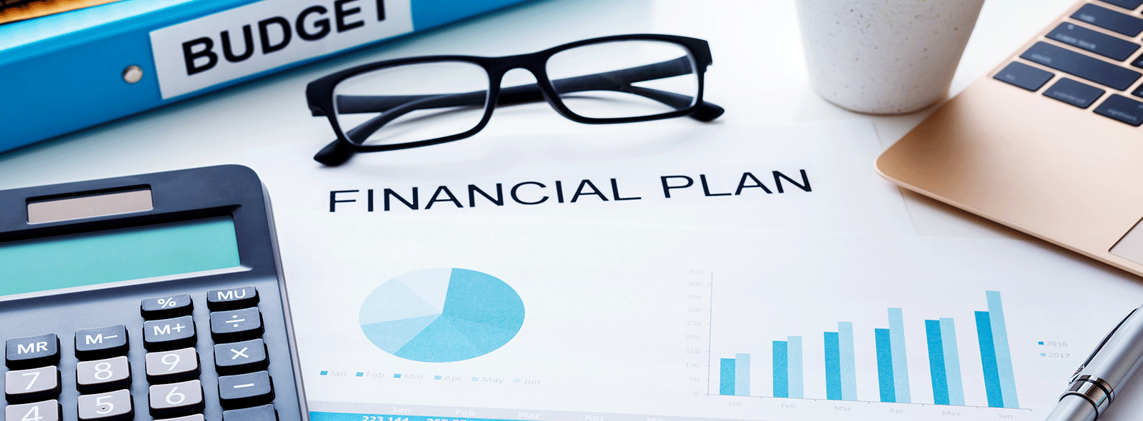 Financial Planning Image with calculator, glasses and computer