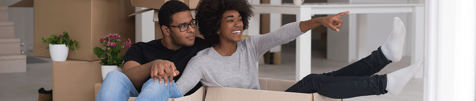 couple in boxes in new home