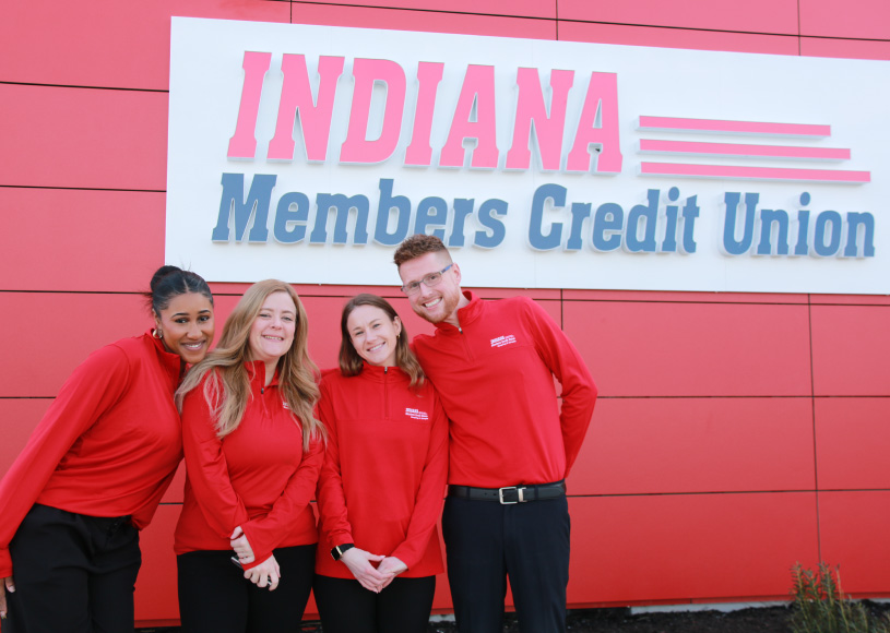 four employees in front of red branch