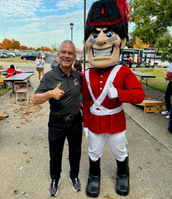 person with iu mascot