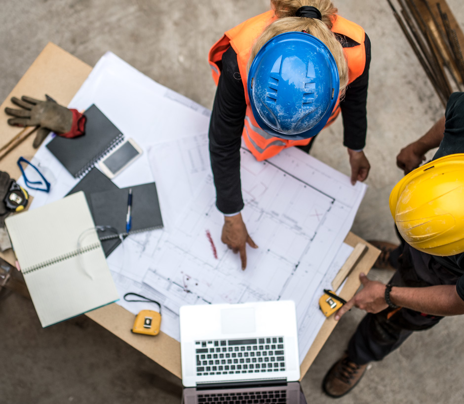 construction workers looking at blueprints