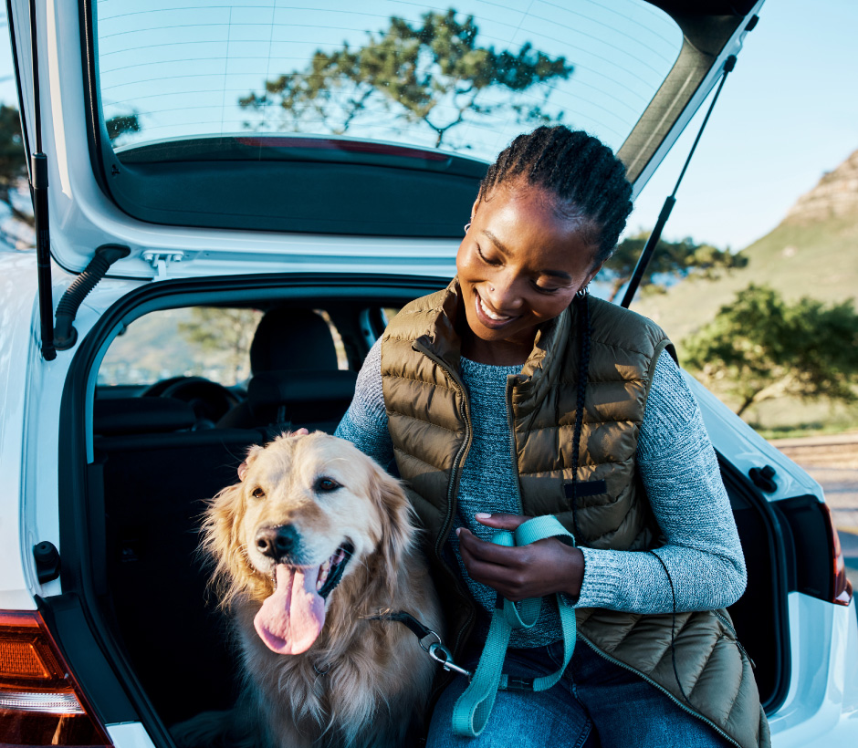 lady with dog in the back of suv