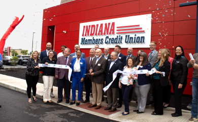 people with ribbon cutting at grand opening