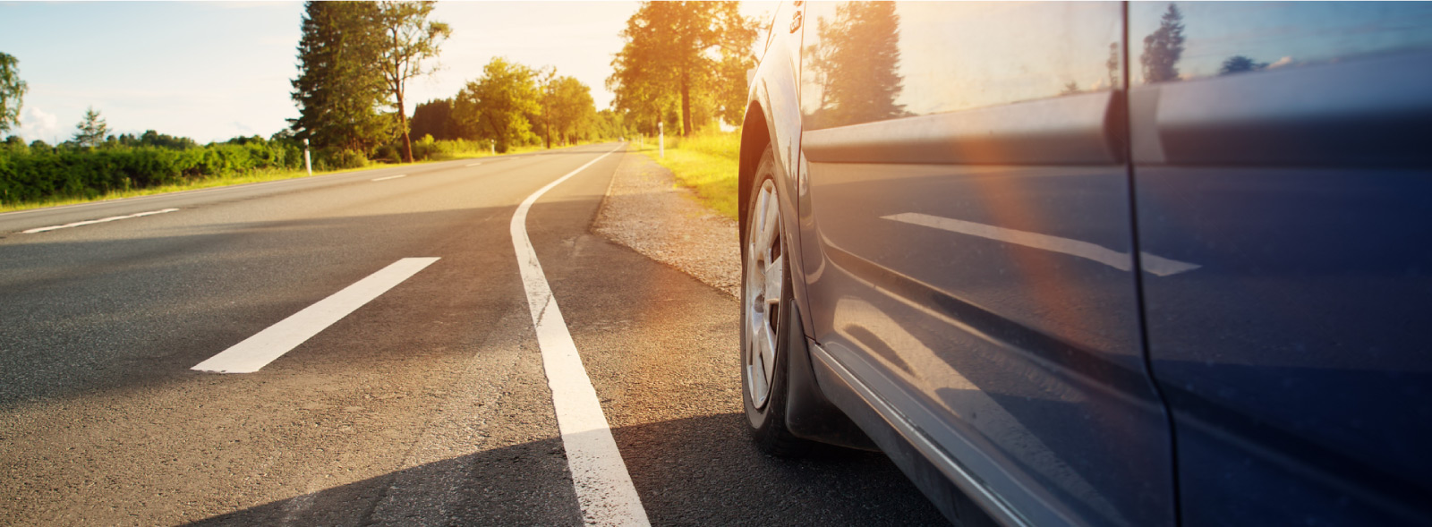 A car driving on road during sunset