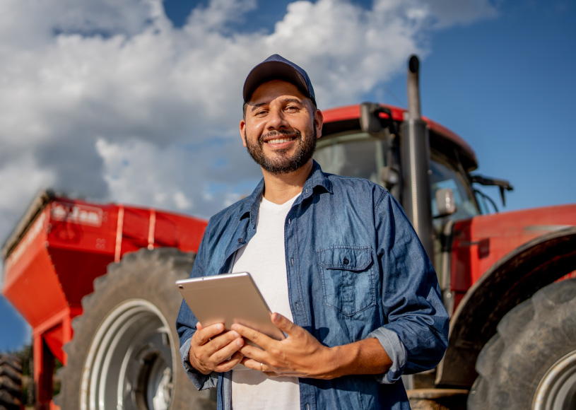 person holding tablet in front of machinery