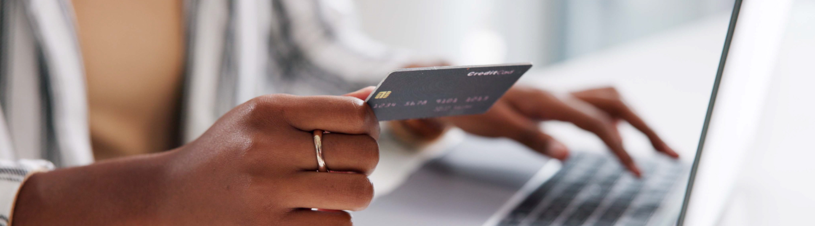 hand holding card with laptop