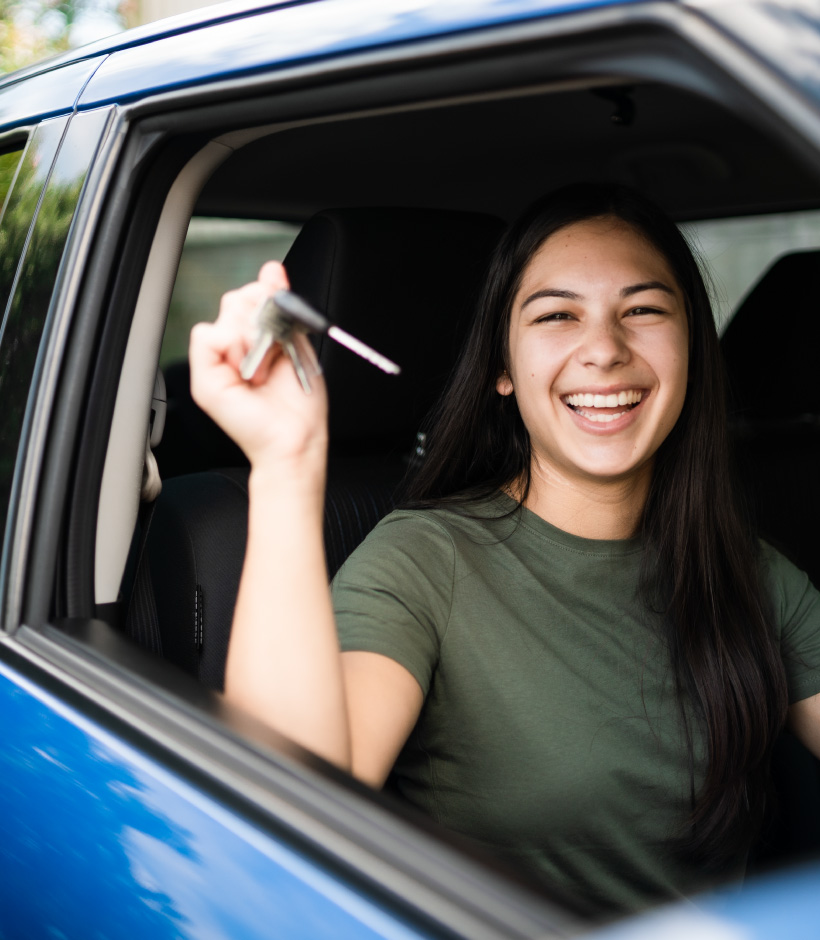 girl holding car keys in car