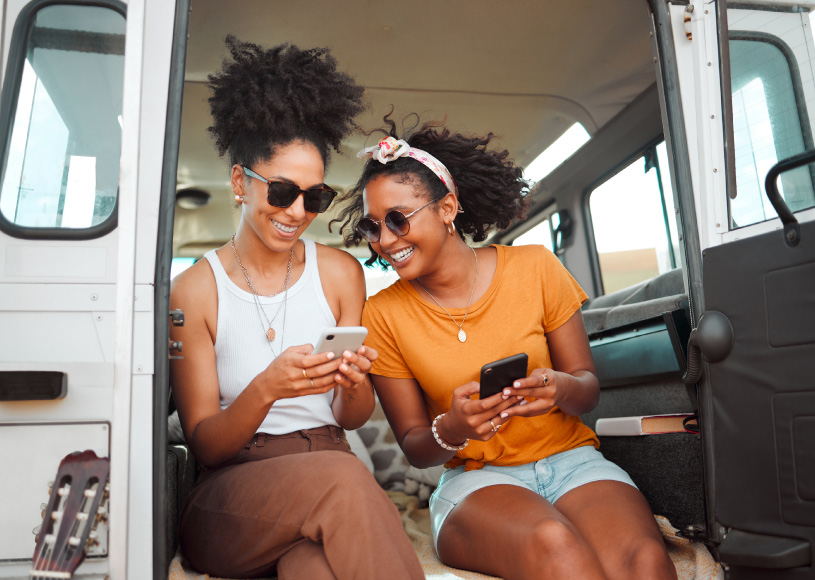 people looking at phones in back of vehicle