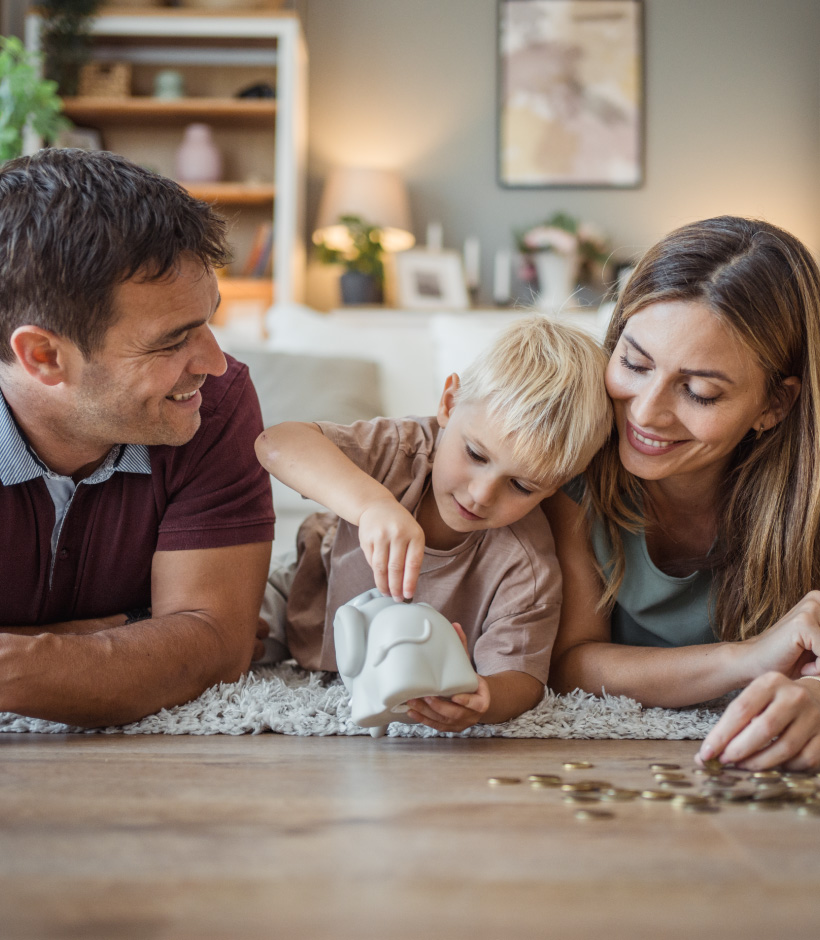 family counting money into piggy bank