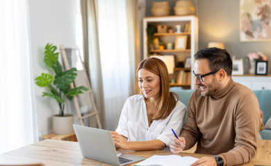 couple reading something on laptop
