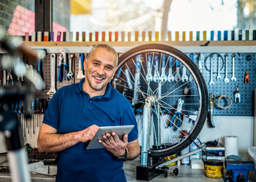 person looking at tablet in bike shop