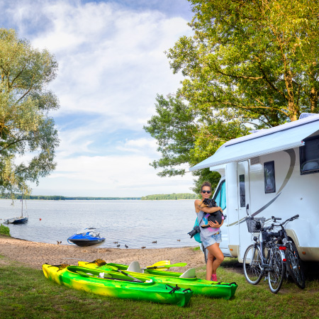 person with adventure gear by their camper