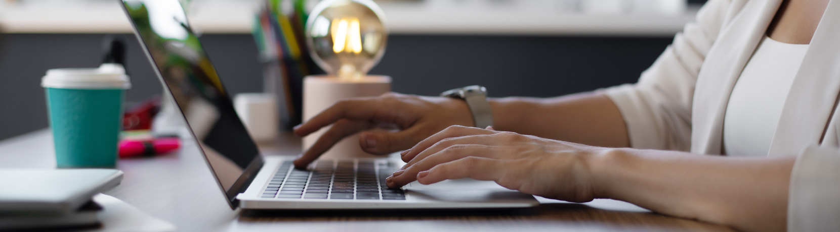 hands typing on laptop