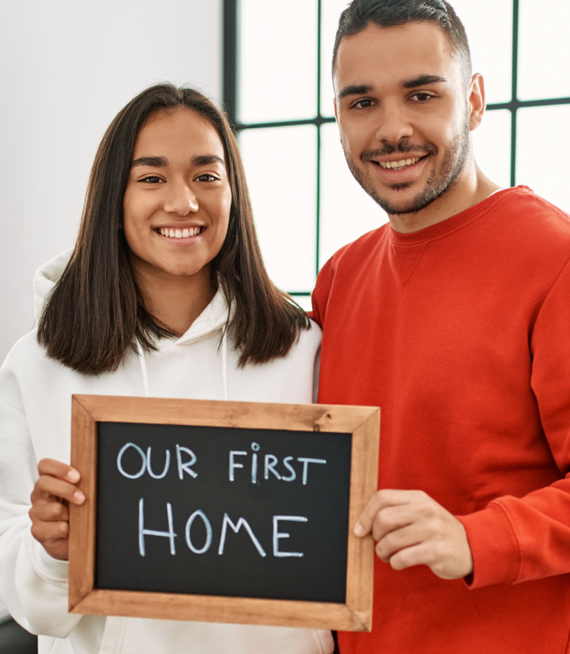 couple holding sign of 