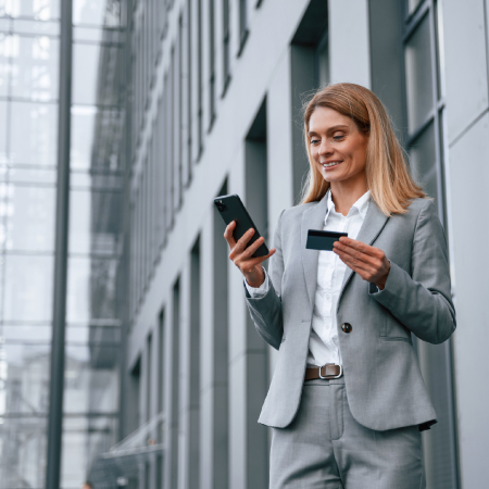 person looking at phone and card
