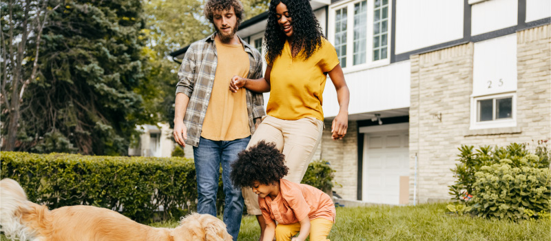 Family with dog outside of house