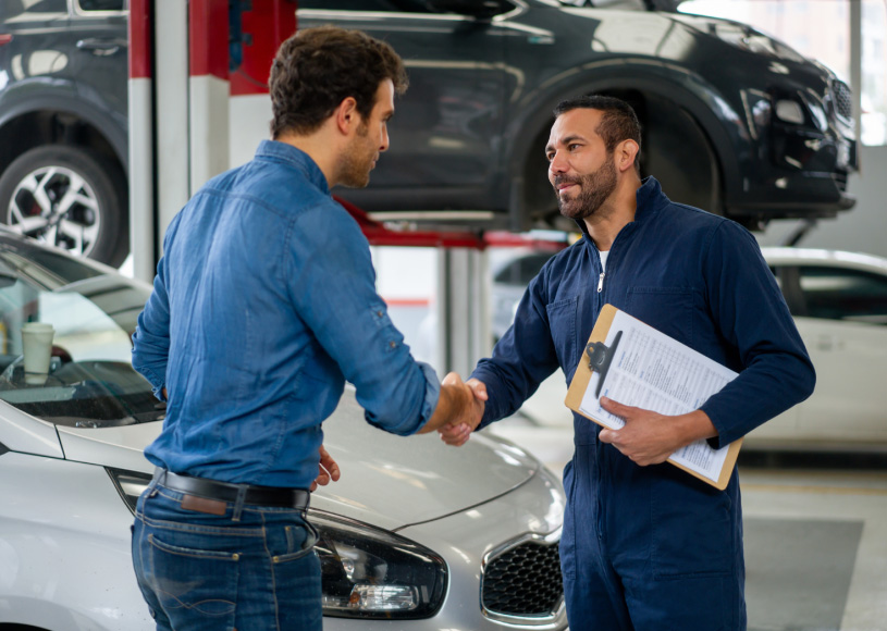 mechanic shaking the hand of a person