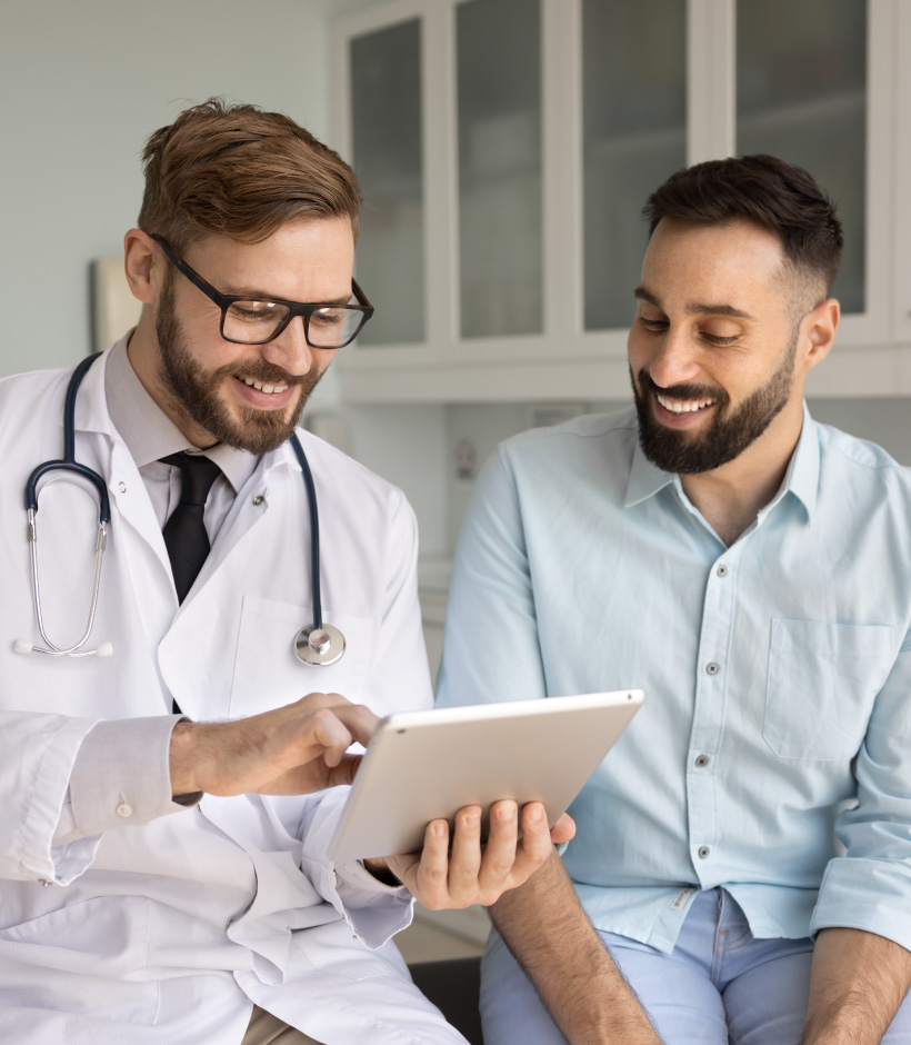 doctor and person looking at a tablet