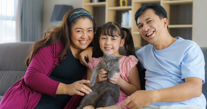 family on a couch with cat