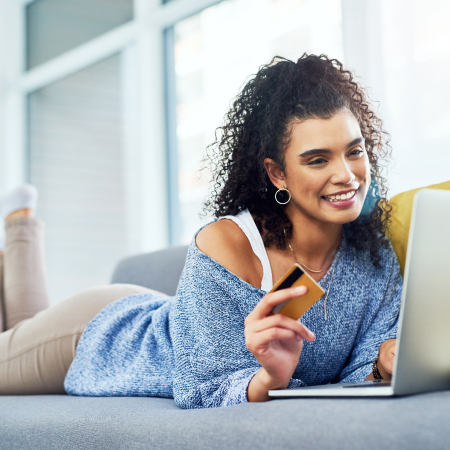 person looking at card at laptop