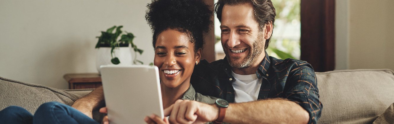 couple on couch with tablet