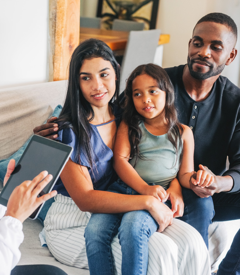 family looking a person holding a tablet