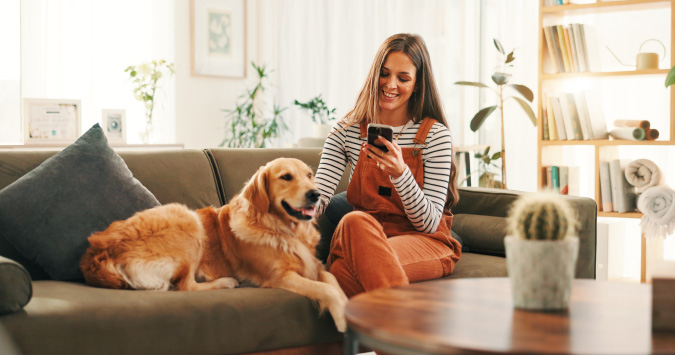 person looking at phone with dog