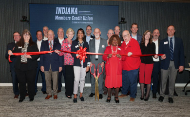 People with grand opening ribbon