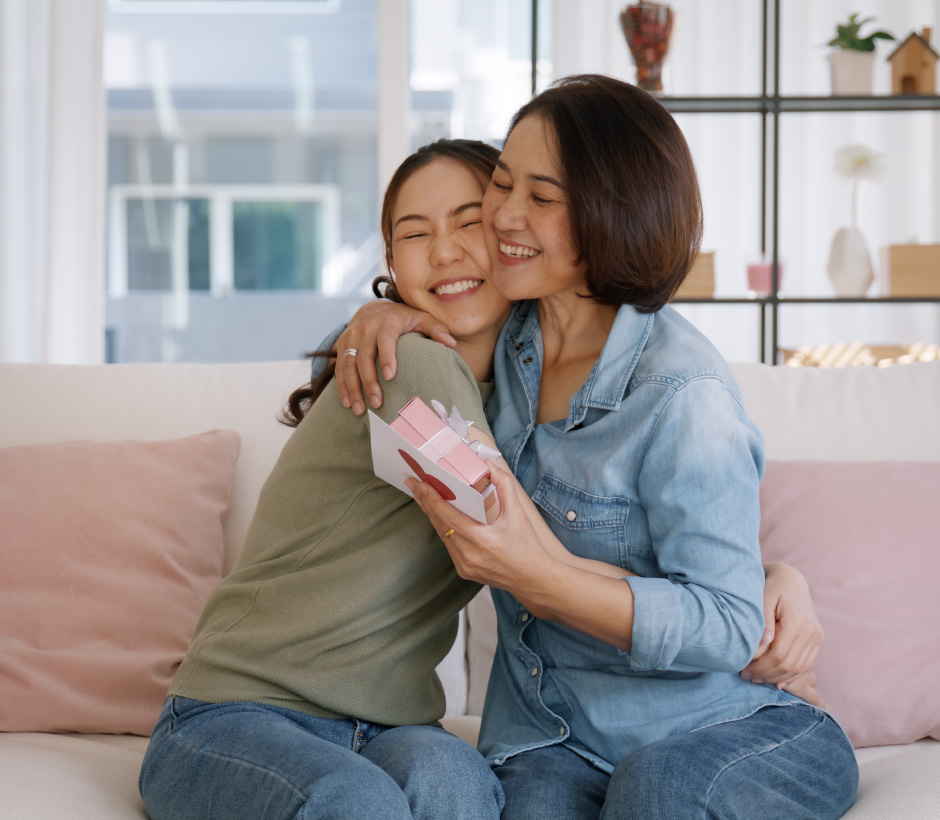 people hugging and receiving a gift