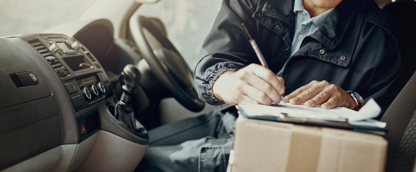 A man doing paperwork in a commercial vehicle