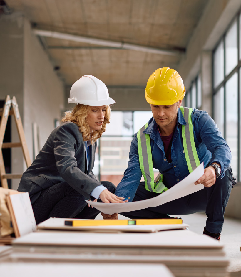 two people looking at blueprints