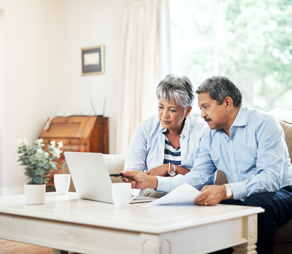 couple reading laptop and papers