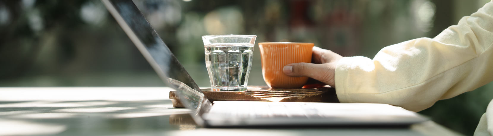 hand with coffee and laptop