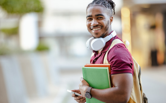 student with backpack and books