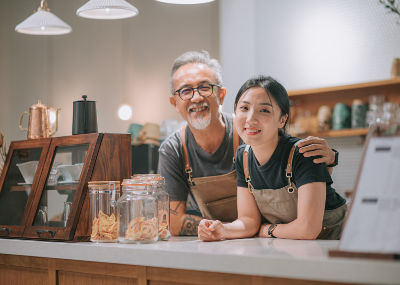 two people behind counter at a business